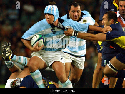 Rugby Union - World Cup 2003 - Argentina vs Romania - Brisbane. Argentina`s Martin Durand (centre) holds off Romania`s Florin Tatu in their Rugby World Cup game at the Aussie stadium in Sydney, Australia. Stock Photo